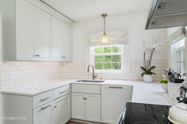 4051 Sutherland Ave, Knoxville, TN 37919 - kitchen featuring a sink, plenty of natural light, tasteful backsplash, and light countertops