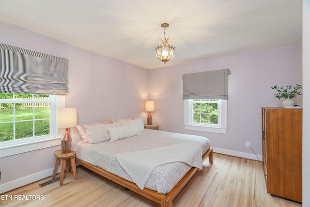 4051 Sutherland Ave, Knoxville, TN 37919 - bedroom with multiple windows, baseboards, and a chandelier