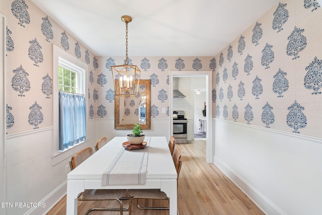4051 Sutherland Ave, Knoxville, TN 37919 - dining area with a chandelier, light wood-type flooring, wallpapered walls, and baseboards