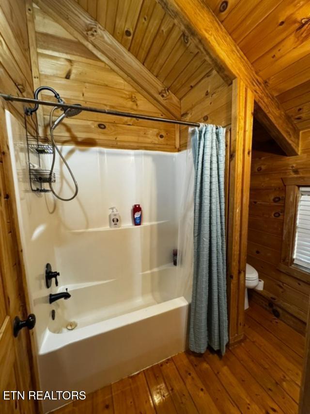 208 Charles Eaves Ln, Benton, TN 37307 - full bath with wood ceiling, hardwood / wood-style flooring, wooden walls, shower / bath combo, and toilet