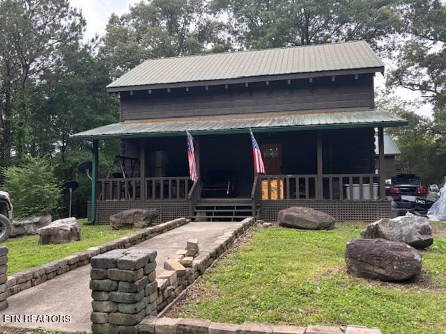 208 Charles Eaves Ln, Benton, TN 37307 - view of front facade with metal roof, a porch, and a front lawn