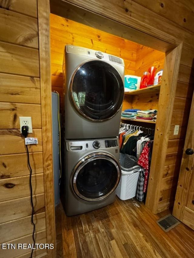 208 Charles Eaves Ln, Benton, TN 37307 - washroom with stacked washer / drying machine, wood finished floors, and wood walls