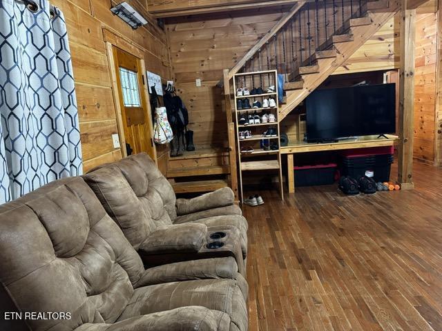 208 Charles Eaves Ln, Benton, TN 37307 - living area with wood walls, hardwood / wood-style floors, and stairway