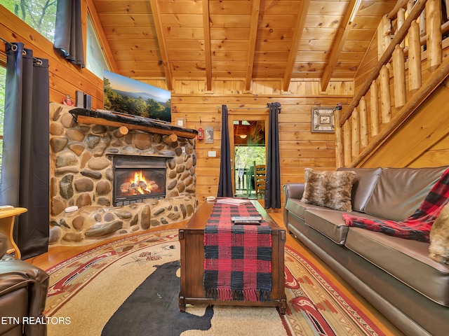 living room featuring wooden ceiling, a fireplace, and wood walls