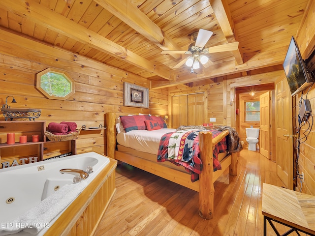 bedroom featuring wood walls, wood ceiling with exposed beams, and light wood-style flooring