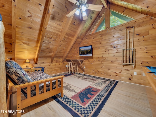 living area with wood ceiling, wood walls, wood finished floors, and ceiling fan