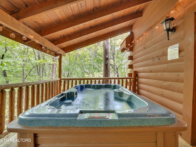 wooden terrace featuring a hot tub