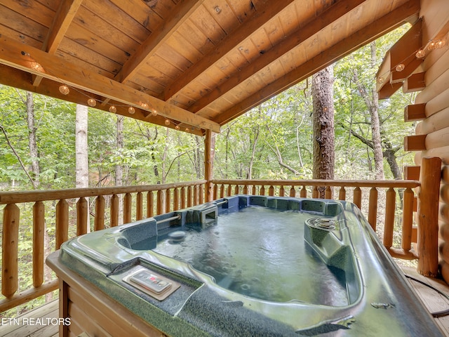 wooden deck with a hot tub