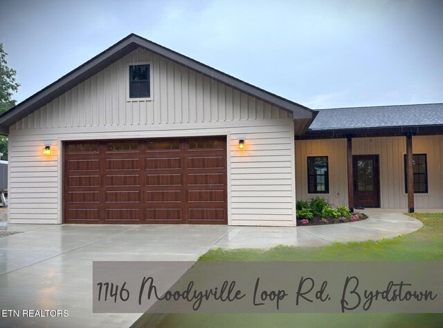 1146 Moodyville Loop, Byrdstown, TN 38549 - view of front of house with board and batten siding and a garage