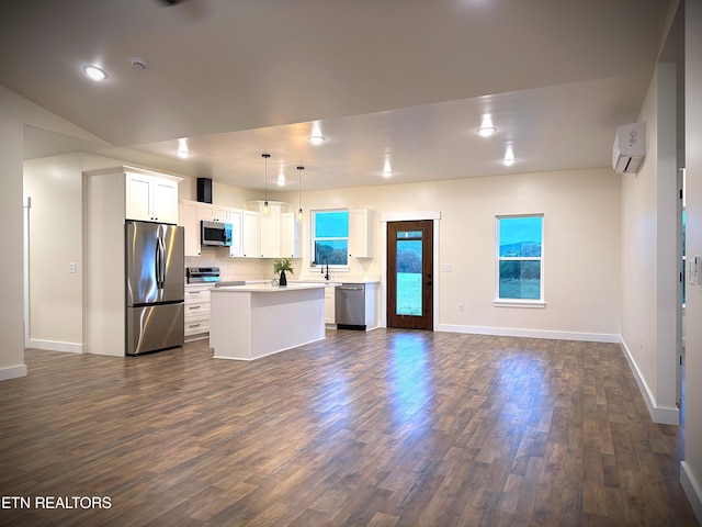 1146 Moodyville Loop, Byrdstown, TN 38549 - kitchen featuring stainless steel appliances, dark wood-style flooring, a kitchen island, open floor plan, and light countertops