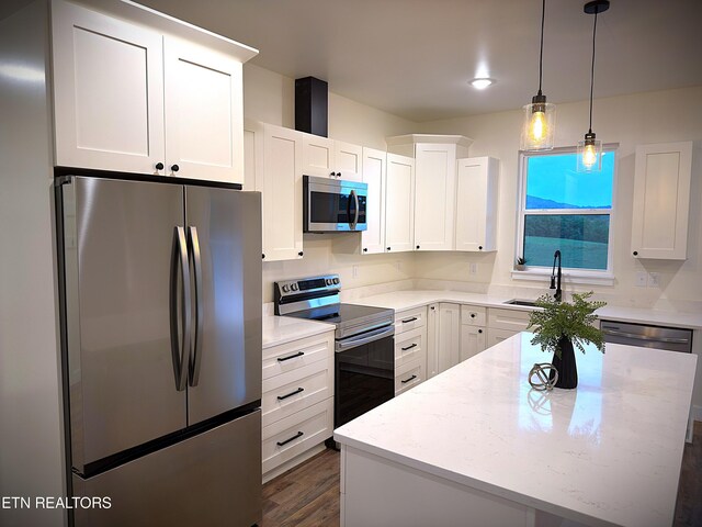 1146 Moodyville Loop, Byrdstown, TN 38549 - kitchen with stainless steel appliances, white cabinetry, decorative light fixtures, a center island, and light stone counters