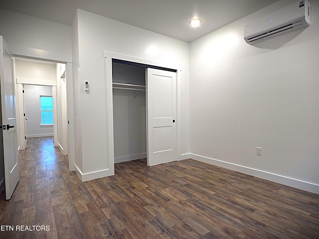 1146 Moodyville Loop, Byrdstown, TN 38549 - unfurnished bedroom featuring a wall unit AC, dark wood finished floors, and a closet