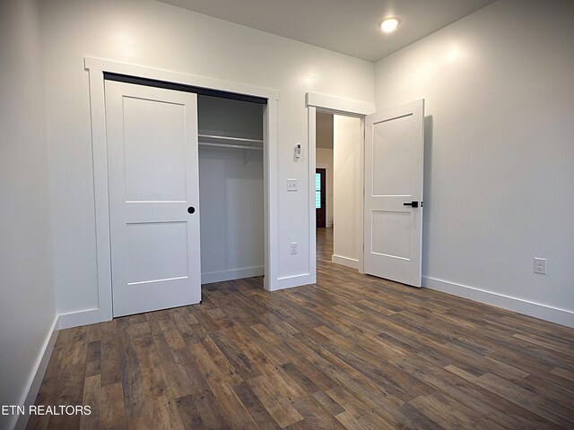 1146 Moodyville Loop, Byrdstown, TN 38549 - unfurnished bedroom with dark wood-style floors and a closet