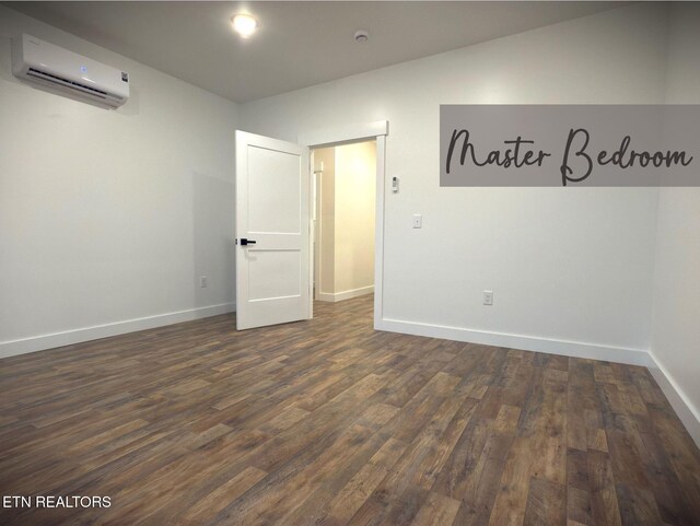 1146 Moodyville Loop, Byrdstown, TN 38549 - spare room with a wall unit AC and dark wood finished floors