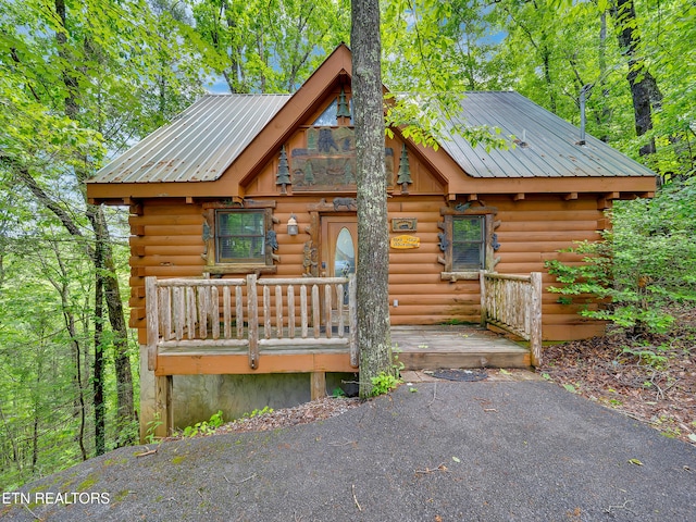 log cabin with log siding and metal roof
