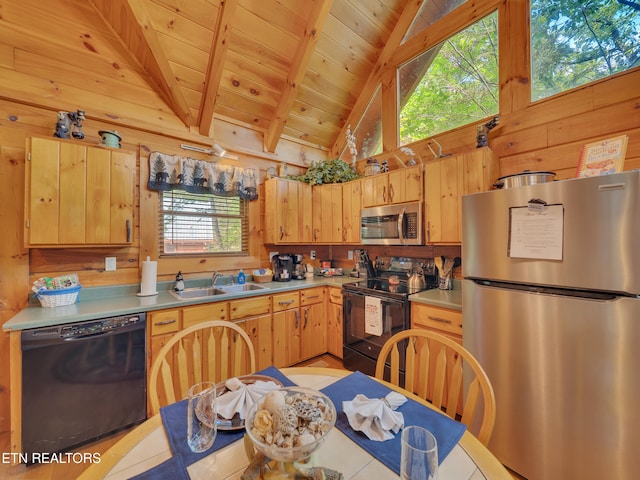 kitchen featuring black appliances, a sink, wood walls, wooden ceiling with exposed beams, and light brown cabinets