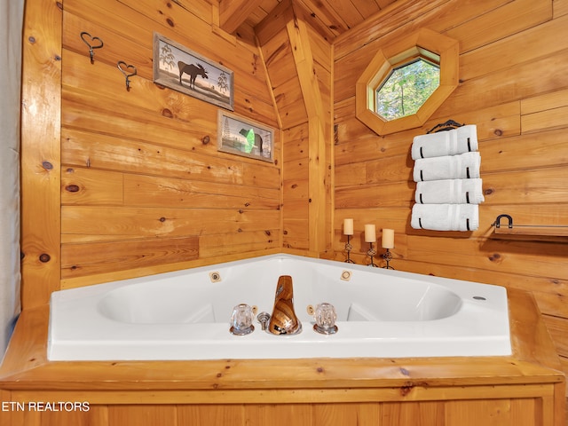 full bathroom with a jetted tub and wooden walls