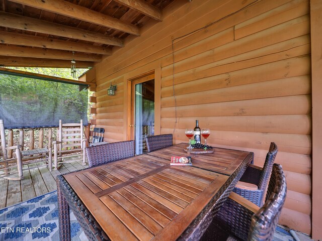 wooden terrace with outdoor dining area