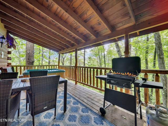 wooden deck with outdoor dining space and a grill