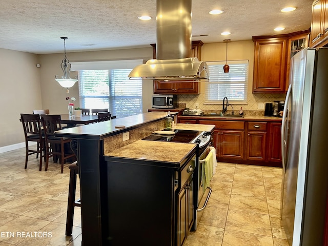 1018 Southwind Cir, Dandridge, TN 37725 - kitchen with stainless steel appliances, a sink, island range hood, decorative backsplash, and a breakfast bar