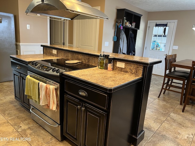 1018 Southwind Cir, Dandridge, TN 37725 - kitchen featuring exhaust hood, stainless steel appliances, dark cabinets, a textured ceiling, and a wainscoted wall