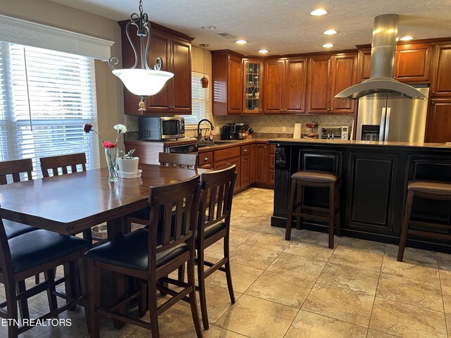 1018 Southwind Cir, Dandridge, TN 37725 - kitchen with stainless steel appliances, backsplash, glass insert cabinets, brown cabinetry, and recessed lighting