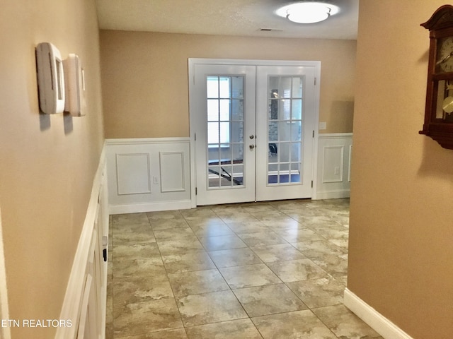 1018 Southwind Cir, Dandridge, TN 37725 - doorway to outside featuring french doors, wainscoting, and a decorative wall