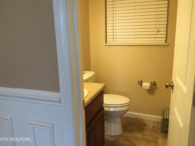 1018 Southwind Cir, Dandridge, TN 37725 - half bathroom featuring toilet, vanity, baseboards, and tile patterned flooring