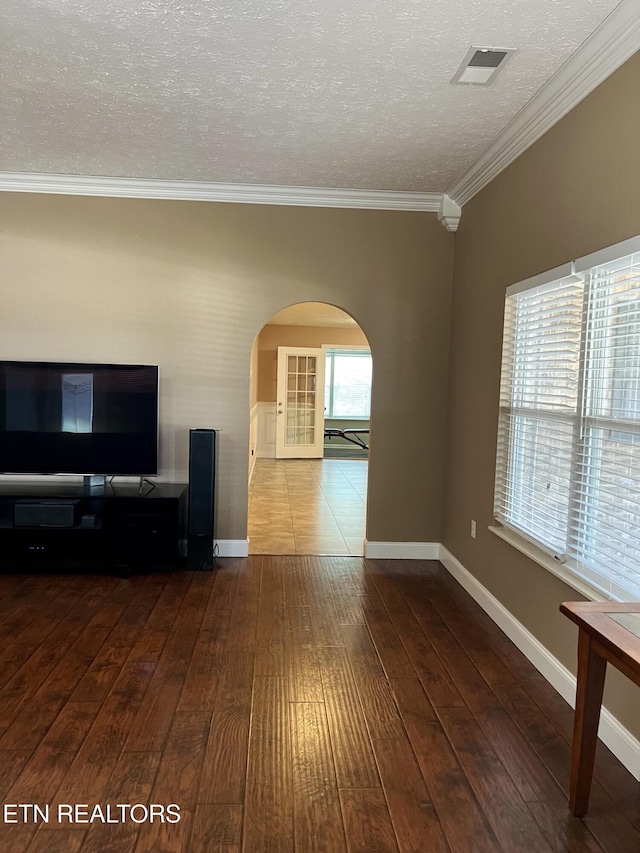 1018 Southwind Cir, Dandridge, TN 37725 - unfurnished living room featuring hardwood / wood-style flooring, arched walkways, crown molding, a textured ceiling, and baseboards