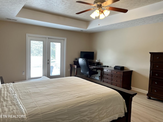 1018 Southwind Cir, Dandridge, TN 37725 - bedroom featuring a tray ceiling, access to exterior, light wood-type flooring, baseboards, and french doors