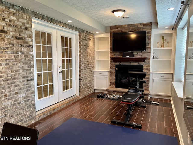 1018 Southwind Cir, Dandridge, TN 37725 - living area with a textured ceiling, french doors, wood tiled floors, a fireplace, and recessed lighting