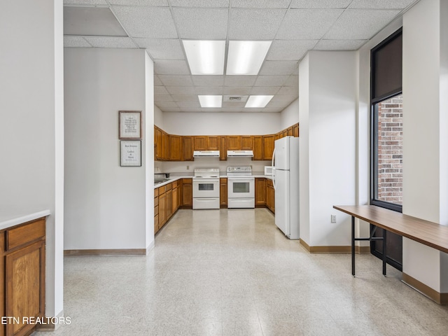 203 Regal Tower, Maryville, TN 37804 - kitchen featuring white appliances, baseboards, a paneled ceiling, ventilation hood, and brown cabinetry