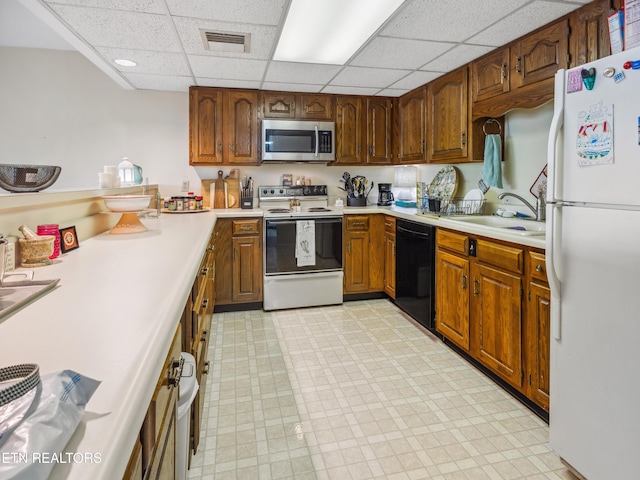 203 Regal Tower, Maryville, TN 37804 - kitchen with white appliances, a sink, a drop ceiling, light countertops, and light flooring