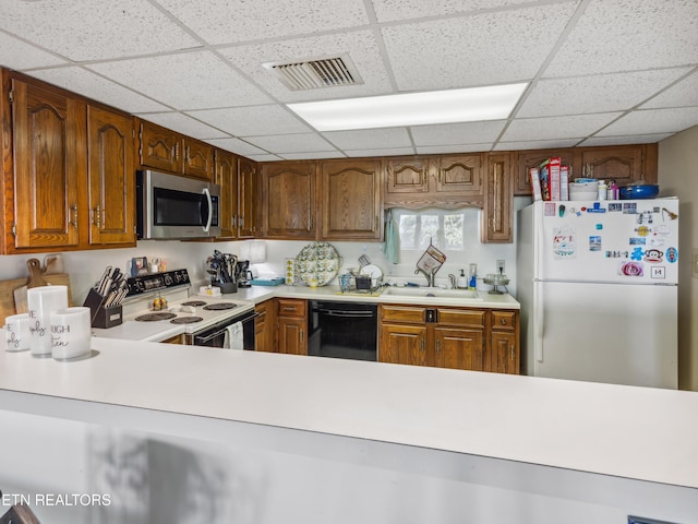 203 Regal Tower, Maryville, TN 37804 - kitchen featuring stainless steel microwave, freestanding refrigerator, electric range, dishwasher, and a drop ceiling