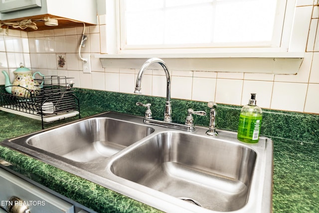 410 Railey Ln, Huntsville, TN 37756 - kitchen view of a sink, decorative backsplash, white cabinets, and dark countertops