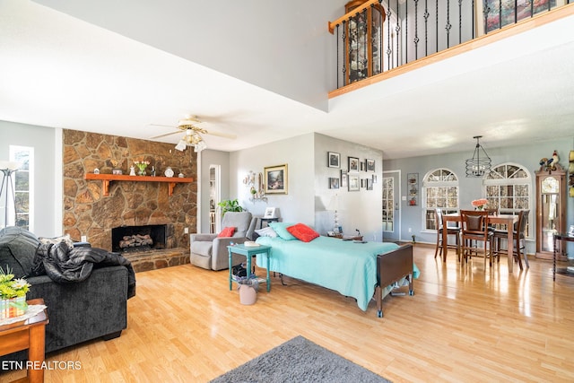 410 Railey Ln, Huntsville, TN 37756 - living area with wood finished floors, a ceiling fan, a stone fireplace, and a chandelier