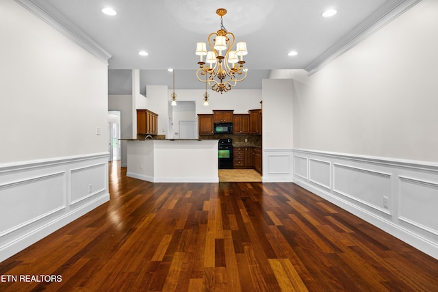 7235 Alysha Vineyard Way, Knoxville, TN 37931 - unfurnished living room featuring a chandelier, a decorative wall, a wainscoted wall, dark wood-style flooring, and recessed lighting