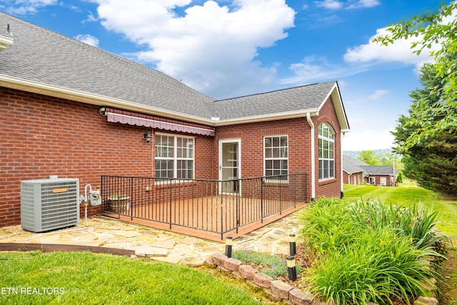 7235 Alysha Vineyard Way, Knoxville, TN 37931 - back of property with cooling unit, a shingled roof, brick siding, and a wooden deck