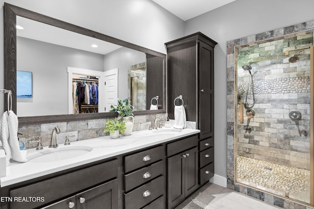 119 Pointe Summit Dr, Greenback, TN 37742 - full bathroom featuring a stall shower, double vanity, a spacious closet, and tile patterned floors