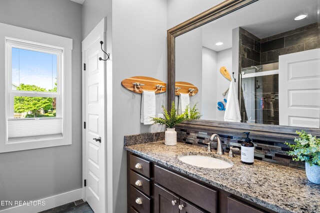 119 Pointe Summit Dr, Greenback, TN 37742 - full bathroom featuring vanity, baseboards, a stall shower, and decorative backsplash