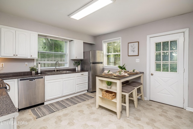 6944 Berry Ln, Knoxville, TN 37914 - kitchen with appliances with stainless steel finishes, a sink, white cabinets, and light floors