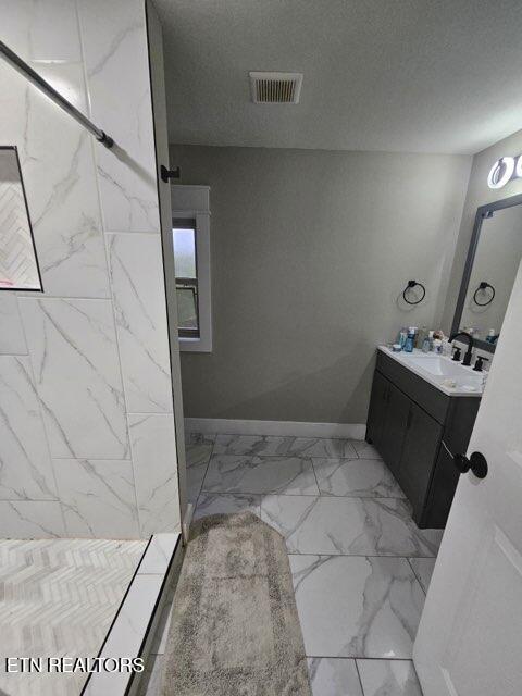828 Noragate Rd, Knoxville, TN 37919 - bathroom featuring vanity, walk in shower, marble look tiles, and baseboards