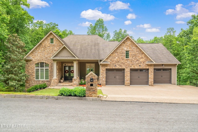 111 Winchester Cir, Oak Ridge, TN 37830 - craftsman-style home featuring french doors, roof with shingles, driveway, an attached garage, and stone siding