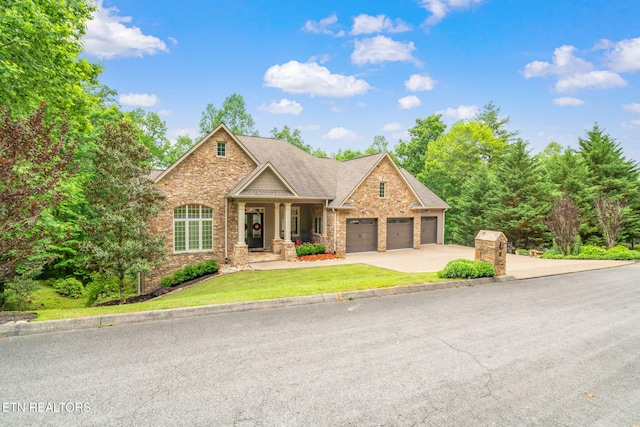 111 Winchester Cir, Oak Ridge, TN 37830 - view of front of property with stone siding, an attached garage, concrete driveway, and a front lawn