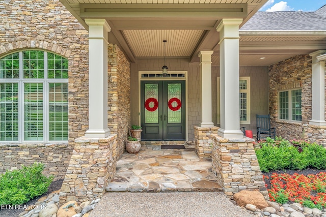 111 Winchester Cir, Oak Ridge, TN 37830 - entrance to property with stone siding, french doors, roof with shingles, and covered porch