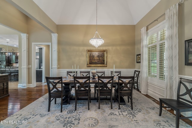 111 Winchester Cir, Oak Ridge, TN 37830 - dining space featuring wood finished floors, decorative columns, a wainscoted wall, a chandelier, and high vaulted ceiling