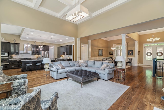 111 Winchester Cir, Oak Ridge, TN 37830 - living room with a chandelier, ornate columns, ornamental molding, a high ceiling, and dark wood-style floors