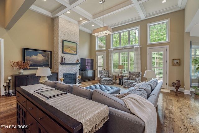 111 Winchester Cir, Oak Ridge, TN 37830 - living room featuring a towering ceiling, coffered ceiling, a fireplace, wood finished floors, and beam ceiling