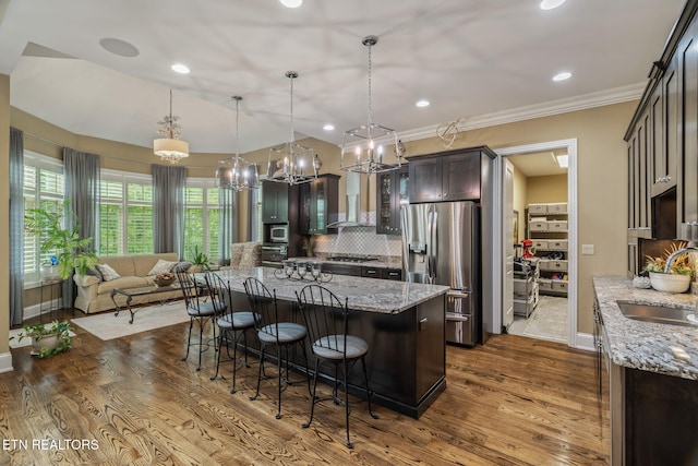 111 Winchester Cir, Oak Ridge, TN 37830 - kitchen with stainless steel appliances, a sink, a chandelier, a kitchen breakfast bar, and dark wood-style floors