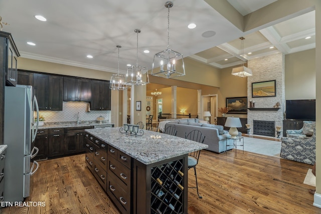 111 Winchester Cir, Oak Ridge, TN 37830 - kitchen featuring freestanding refrigerator, a breakfast bar, ornamental molding, decorative light fixtures, and dark wood finished floors
